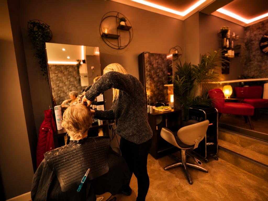 Hair stylist providing professional hairdressing services at Sisters Hair & Beauty in Tavistock.